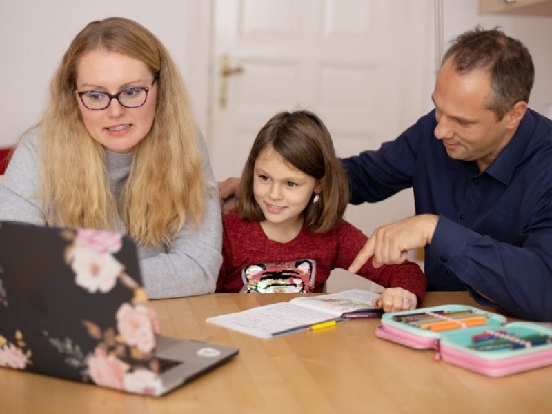 Parents learning together with their child during homeschooling.
