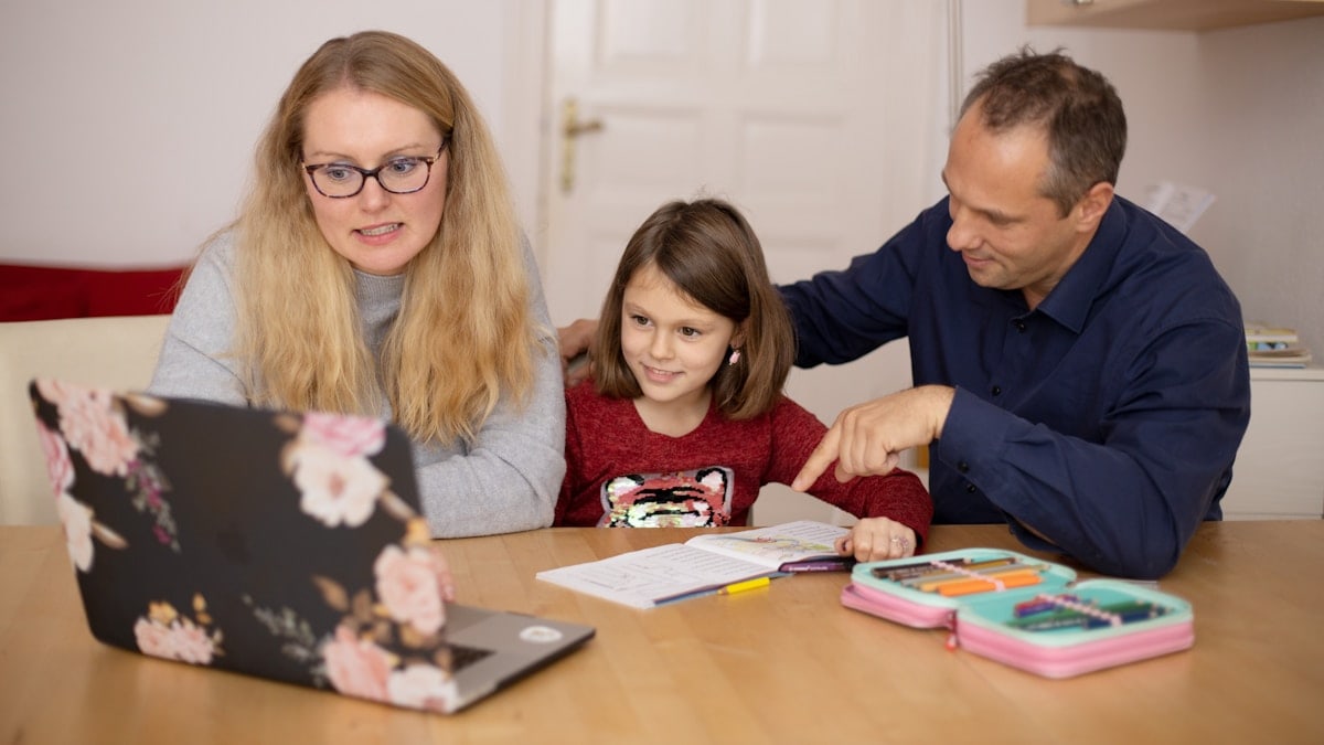 Parents learning together with their child during homeschooling.